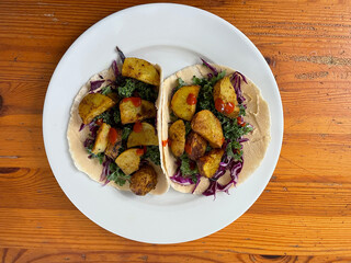 Healthy lunch with potatoes, greens, purple cabbage and hummus
