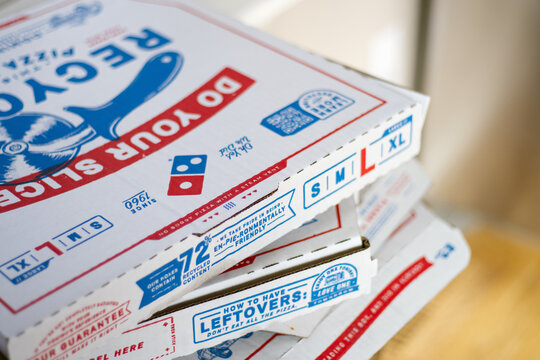Domino's pizza boxes stacked. Food delivery or takeout.