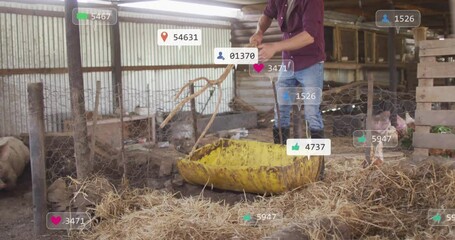 Farmtech marketing farmhand using pitchfork moving straw into cart with floating social icons - Powered by Adobe