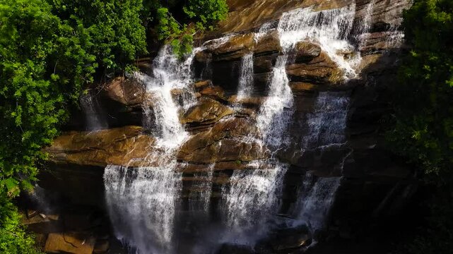 A tropical Olu Ella waterfall in a mountain canyon surrounded by jungle. Sri Lanka.