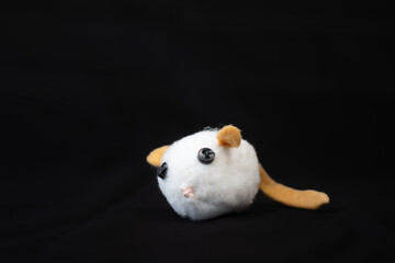 white fake mouse on a black background