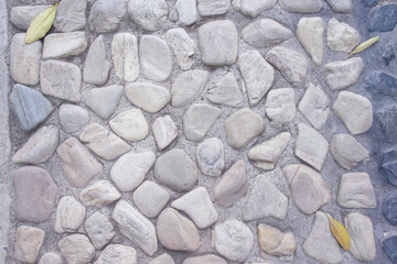 Small stone decorative in cement with dried leaf fall on floor top view background