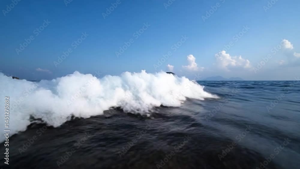 Poster ocean wave cresting under a blue sky with white clouds. the dynamic motion of water creating a sense
