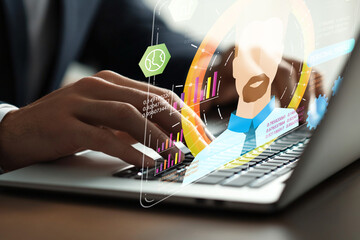 Person Using Laptop with Digital Interface Showing Data Analytics, Graphs, and Business Insights in...