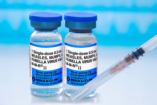 Calgary, Alberta, Canada. May 2, 2025. Two vials of the MMR vaccine and a syringe are displayed, highlighting immunization against measles, mumps, and rubella.
