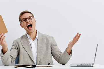 excited man working digital nomad holding envelope wearing glasses grey blazer sitting at desk with...
