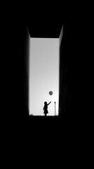 Fototapeta premium Silhouette of a child holding a balloon with negative space above