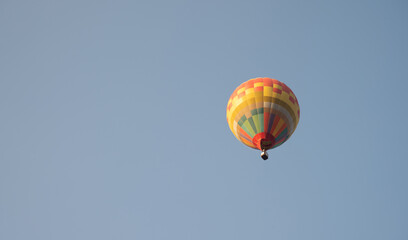Below view of fancy hot air balloon in flight against the sky.