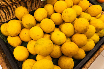 Piles of fresh lemons for sale in supermarkets.