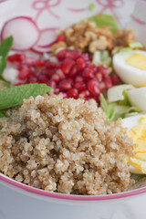 Healthy quinoa salad with fresh vegetables and pomegranate