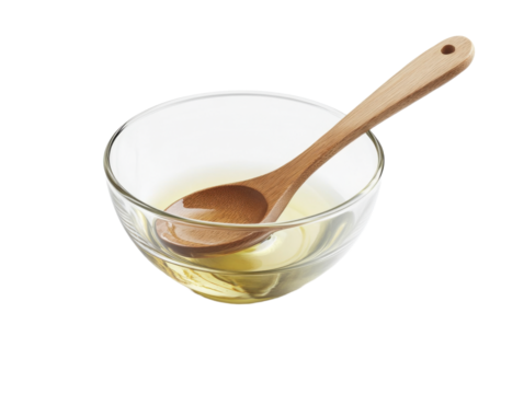  Glass bowl of honey with wooden spoon