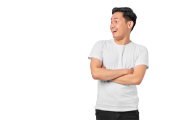 Portrait of amazed young Asian man crossed arms and looking aside at blank space isolated on transparent background