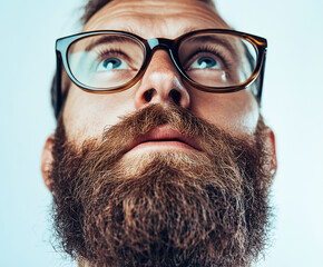 Close-up of a man wearing glasses on a white background, a man wearing glasses looks up