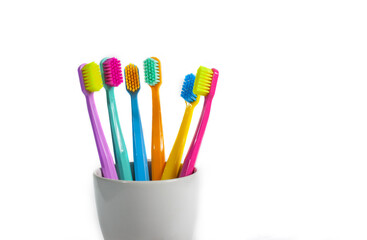 Fototapeta premium A set of multicolored toothbrushes isolated on white background. Design concept for dental and oral health theme.