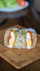 Close up of sandwich on wooden cutting board