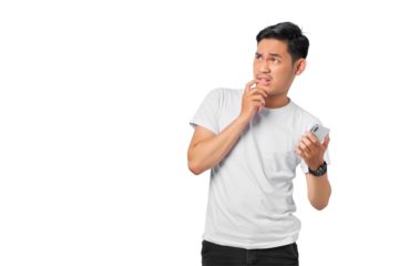 Pensive young Asian man with a serious face thinking about a question, using a mobile phone isolated on transparent background