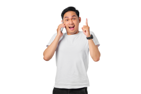 Shocked young Asian man talking on mobile phone and pointing fingers up having a good idea isolated on transparent background