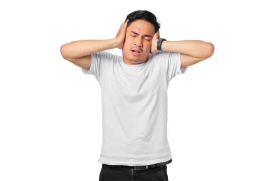 Frustrated young Asian man covering ears with hands and keeping eyes closed isolated on transparent background