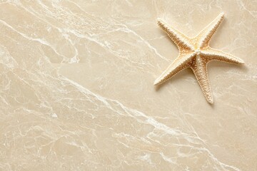 Beige marble surface with starfish.  Top view, natural light