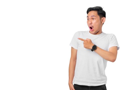 Shocked young Asian man pointing fingers at copy space, advertisement banner isolated on transparent background