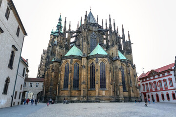 
a majestic Gothic cathedral with tall towers, intricate architectural elements and green roofs...