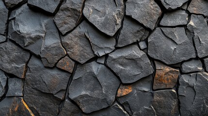 Fototapeta premium Dark gray stone wall texture, close-up view.