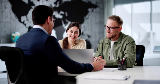 Smiling Travel Agent Assists Young Couple