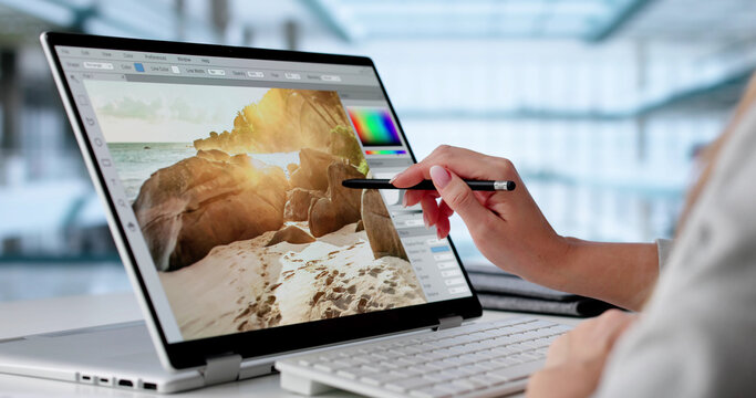 Young Woman Editing Video On Laptop