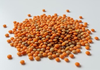 Pile of orange lentils scattered on white background