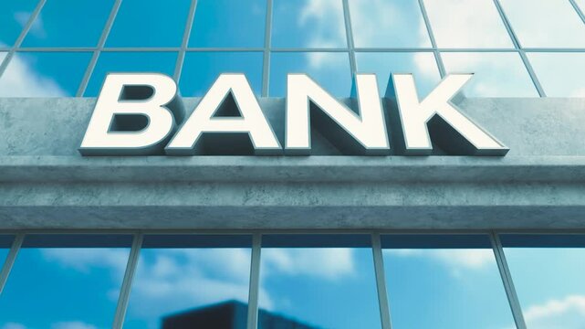 A slow pan across generic signage above the entrance to a modern generic bank building made of exposed concrete and reflective glass in the day time