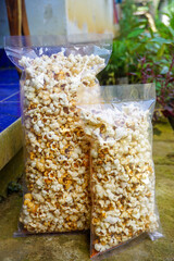 A wooden table with a light snack of crackers and cheese, captured from above