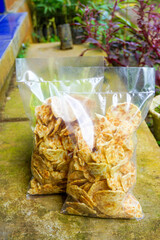 A wooden table with a light snack of crackers and cheese, captured from above