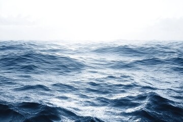 Serene ocean waves under a hazy sky.  Vast, blue expanse