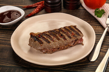 Grilled beef striploin steak with sauce