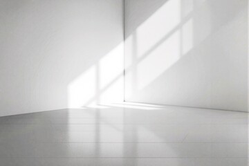 Obraz premium Minimalist white room with sunlight shadows on walls and floor.