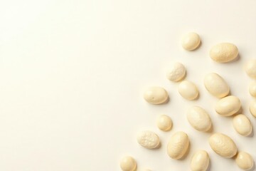 Scattered white beans against bright white backdrop, diet, harvest, agriculture