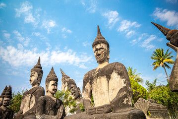 Obraz premium Many Stone Buddha monuments in Xieng Khuan sculpture park under blue sky