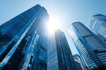 Obraz premium Modern Glass Skyscrapers in a City Center Under Bright Sunlight