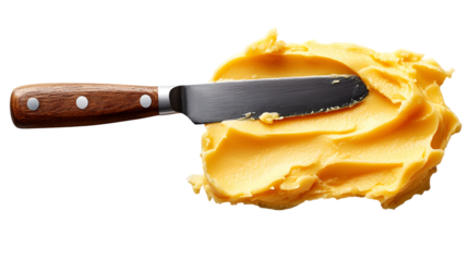 Yellow butter spread with palette knife on black background