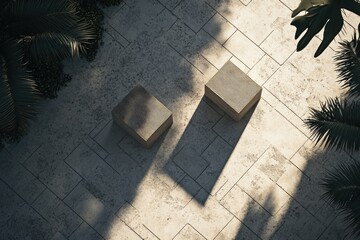 Two light beige blocks on a patterned stone patio, surrounded by tropical plants