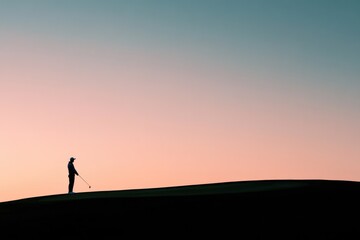 Fototapeta premium Silhouette of golfer against serene sunset sky, capturing tranqu