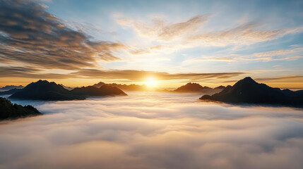 Breathtaking sunrise over mountains with fog enveloping landscape, creating serene atmosphere