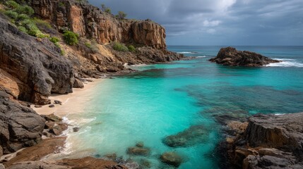 Obraz premium Secluded tropical beach cove with turquoise water and rocky cliffs scenery