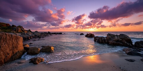 Boulders embrace a tranquil sunset beach