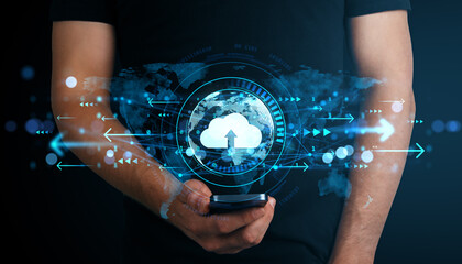 Person holding smartphone with cloud computing hologram and digital data transfer icons on dark background representing modern business technology.