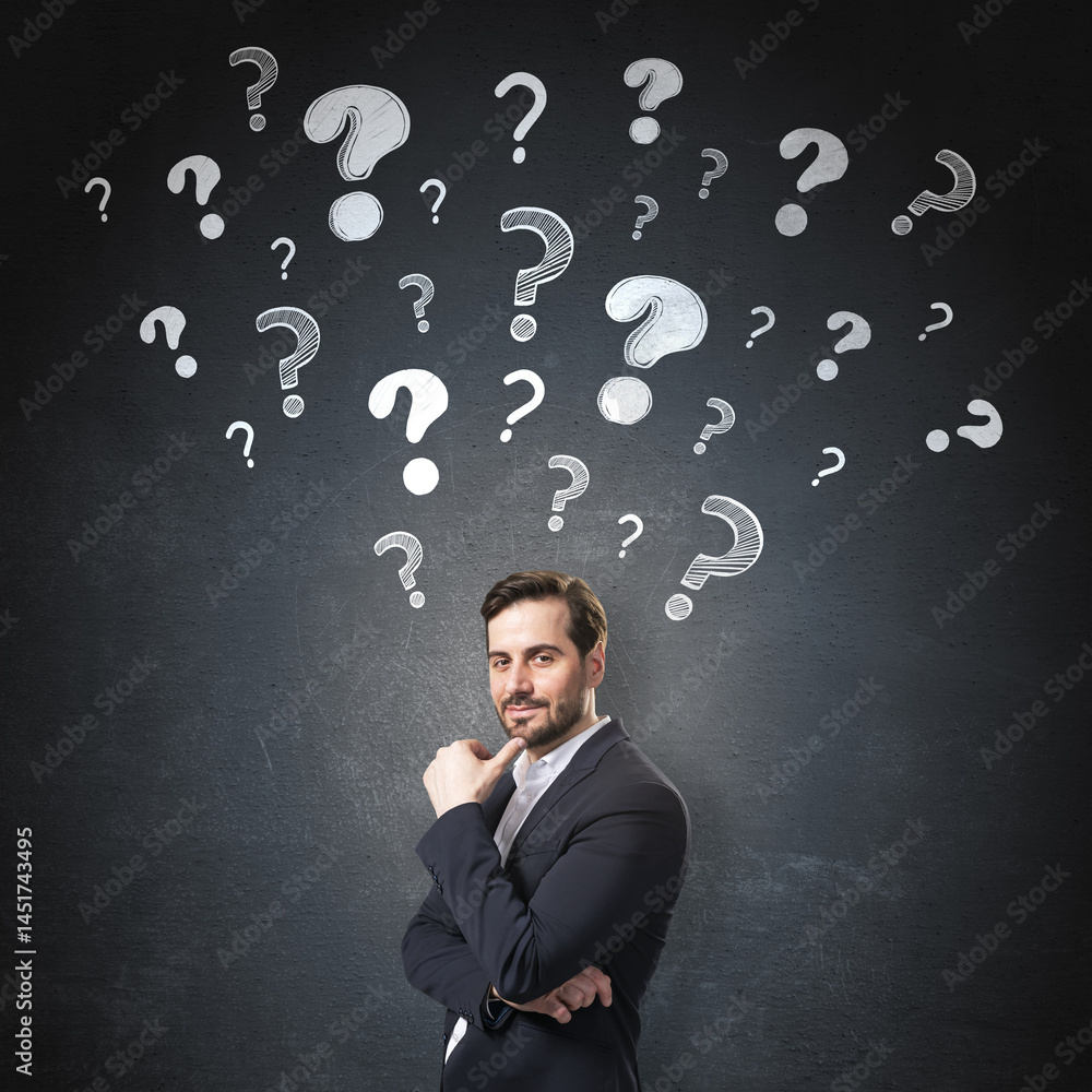 Aufkleber Thoughtful businessman standing in front of dark background with floating question marks symbolizing curiosity, problem-solving, and decision-making.