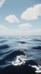 Calm ocean meets a bright, clear sky.  Soft, rippling water stretches to a vast horizon, dotted with puffy white clouds against a vibrant blue sky