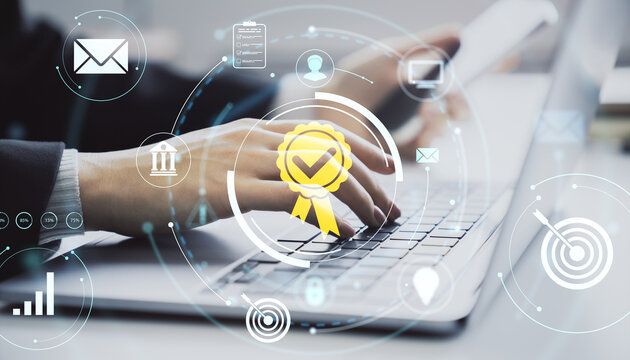 Close-up of business person typing on laptop keyboard with digital certification and data icons on light background for business technology concept.