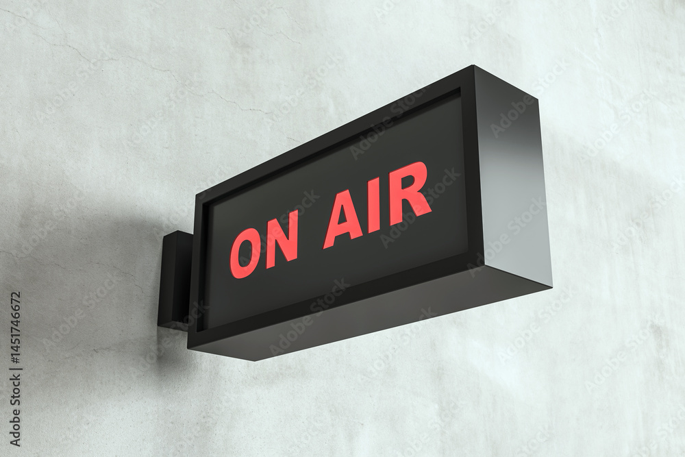 Aufkleber on air illuminated signage box mounted on a concrete wall background, closeup view, modern broadcast