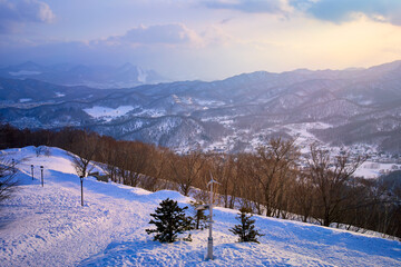 Viewpoint of Moiwa hill with sun light nearly sunset time for travel in winter season sapporo japan.